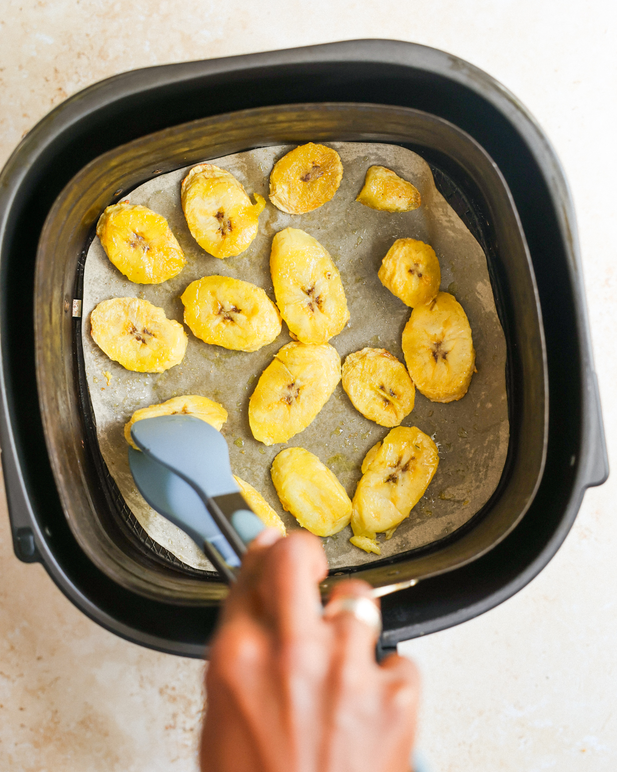overhead flipping the air fried plantains