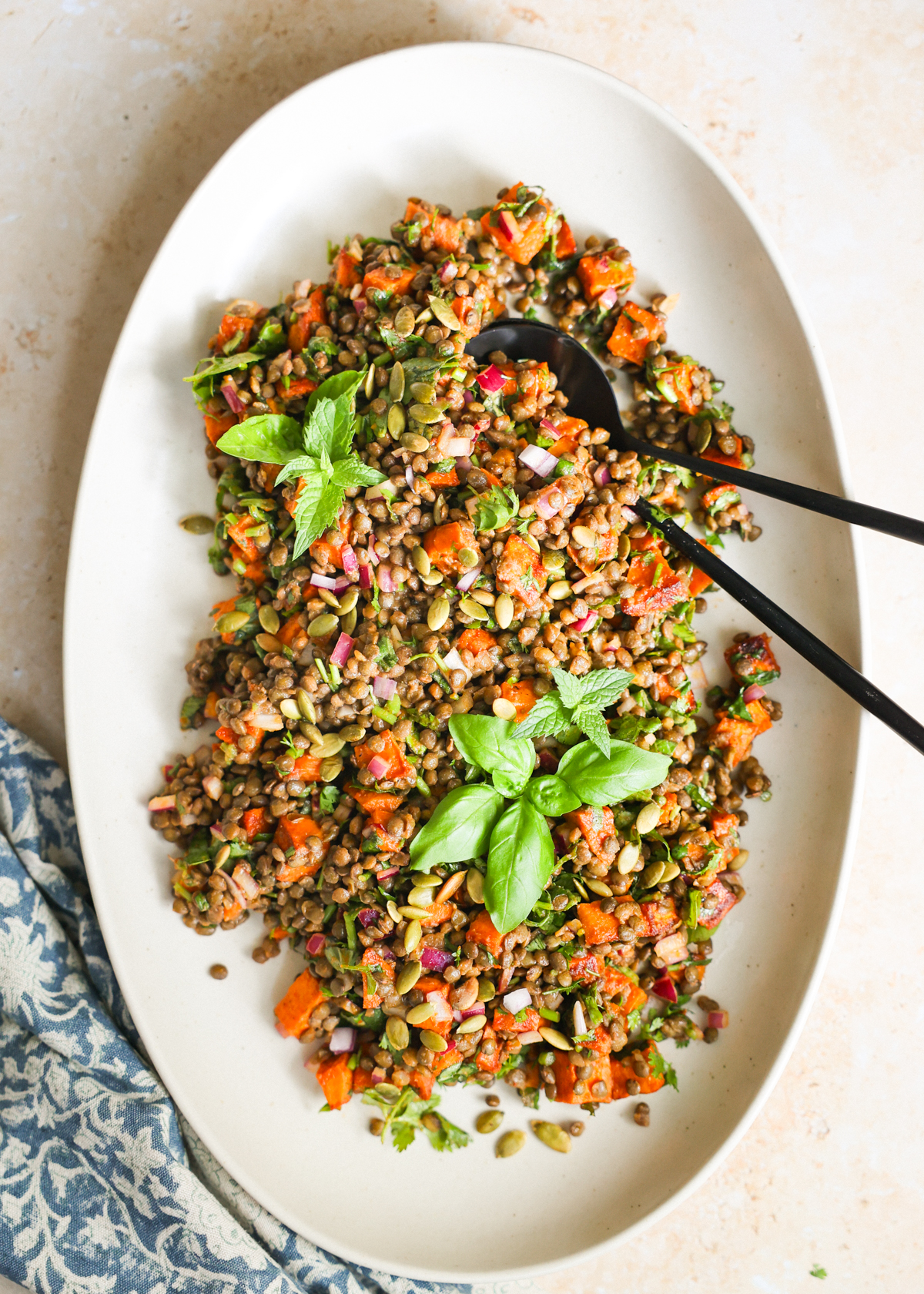 Lentil salad on a white platter.