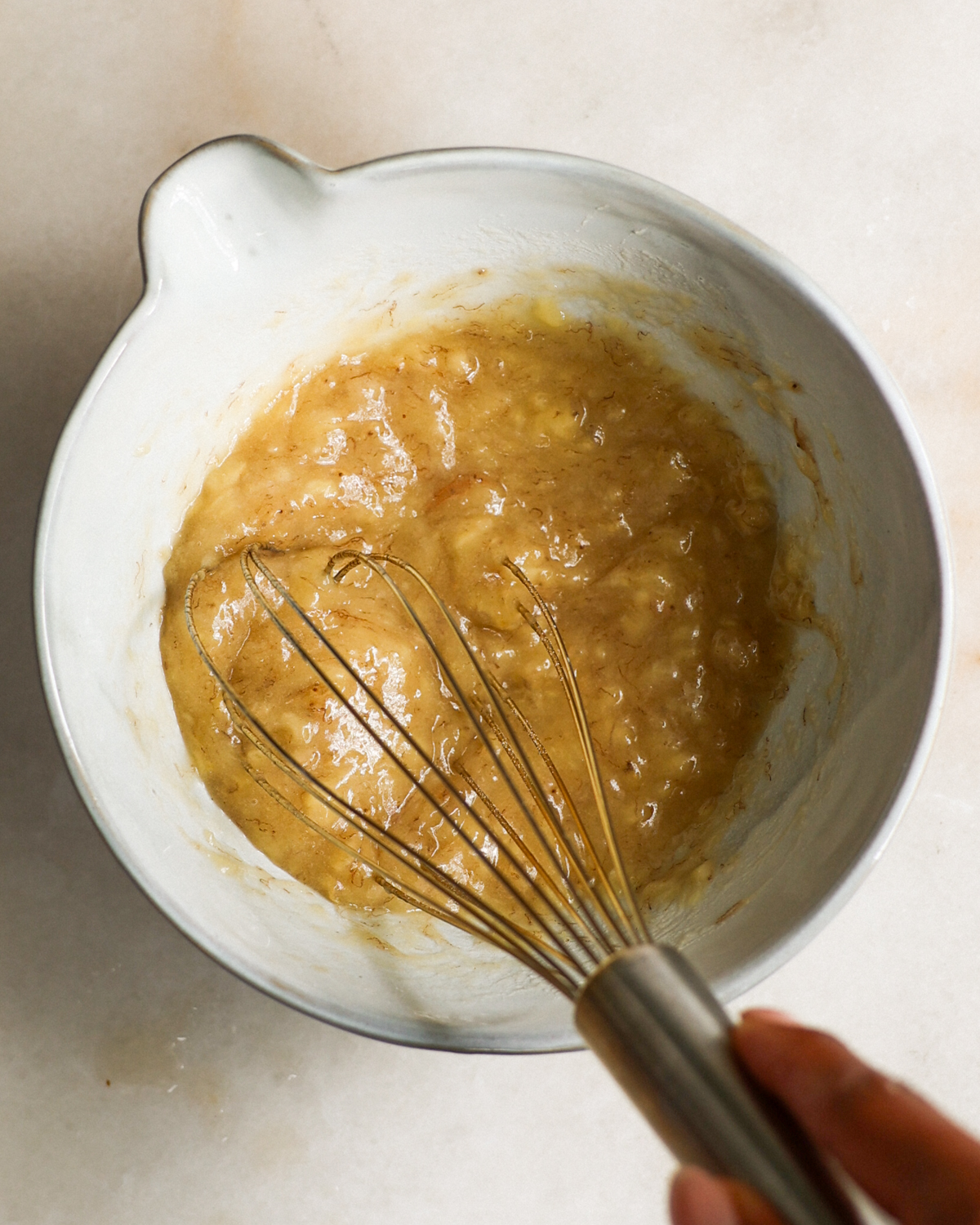 mashing ripe bananas in bowl