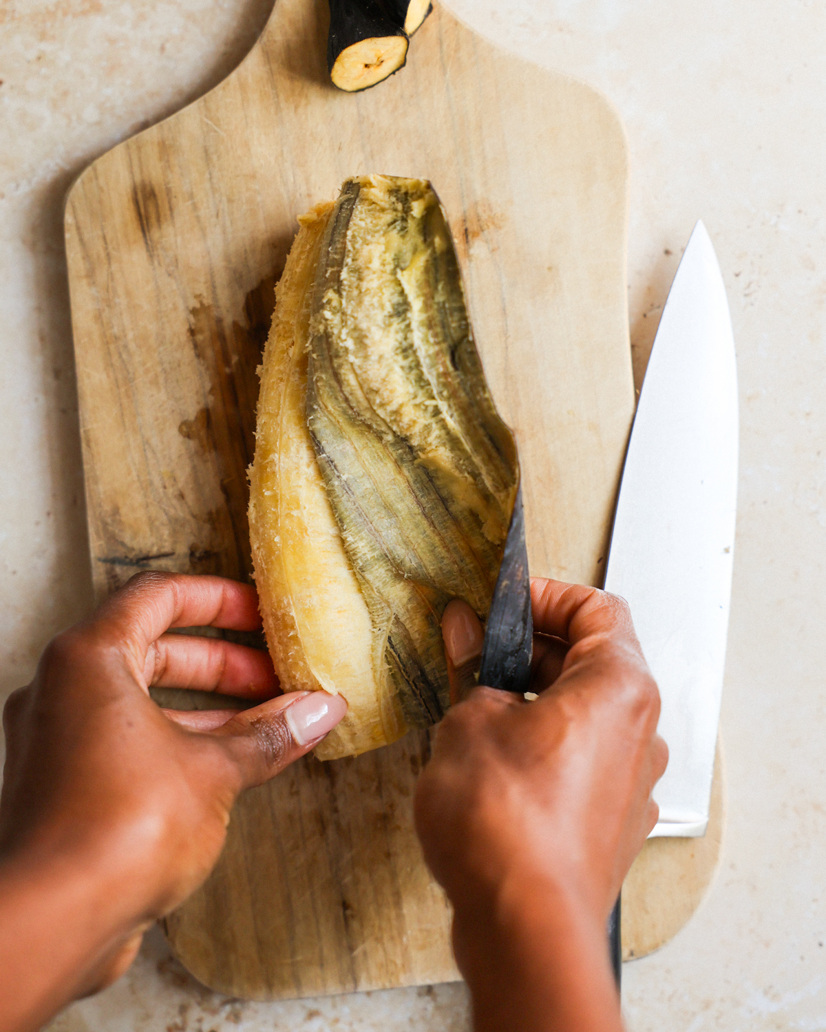 overhead removing peel from the plantain