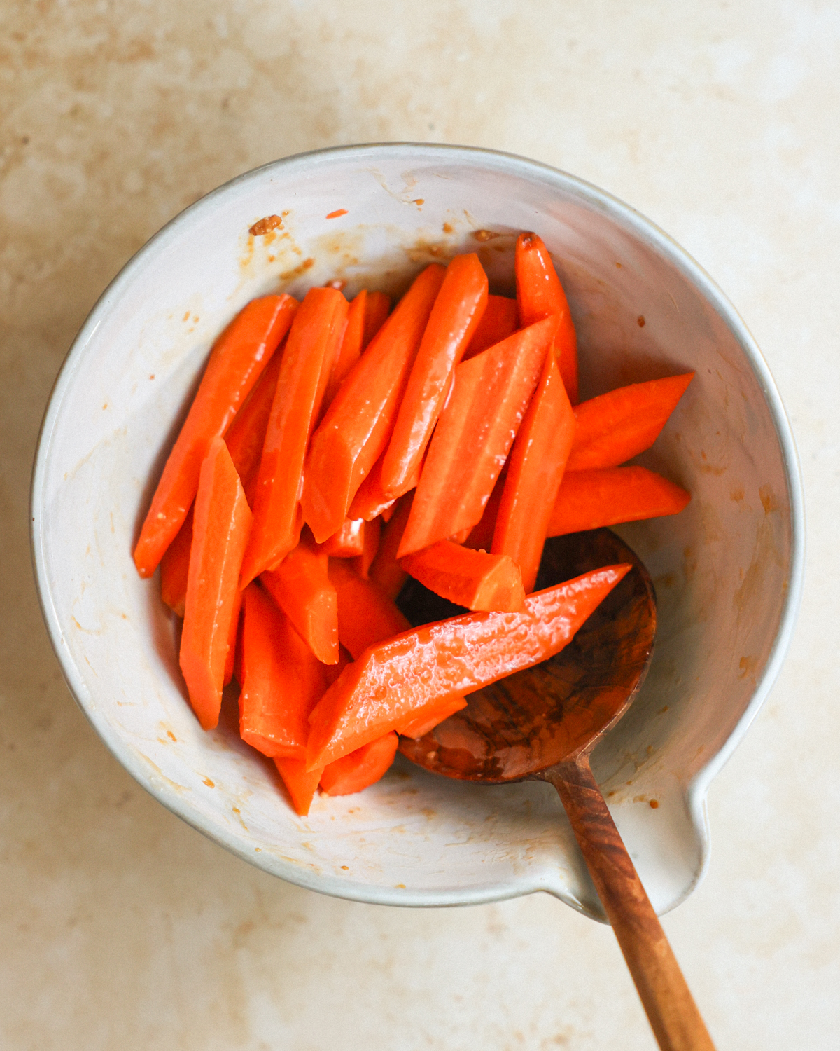 overhead tossing carrots in glaze