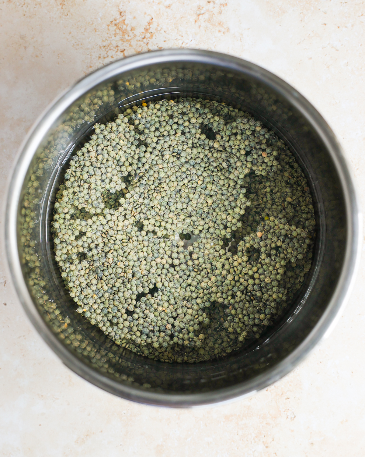 overhead of lentils and water in pot