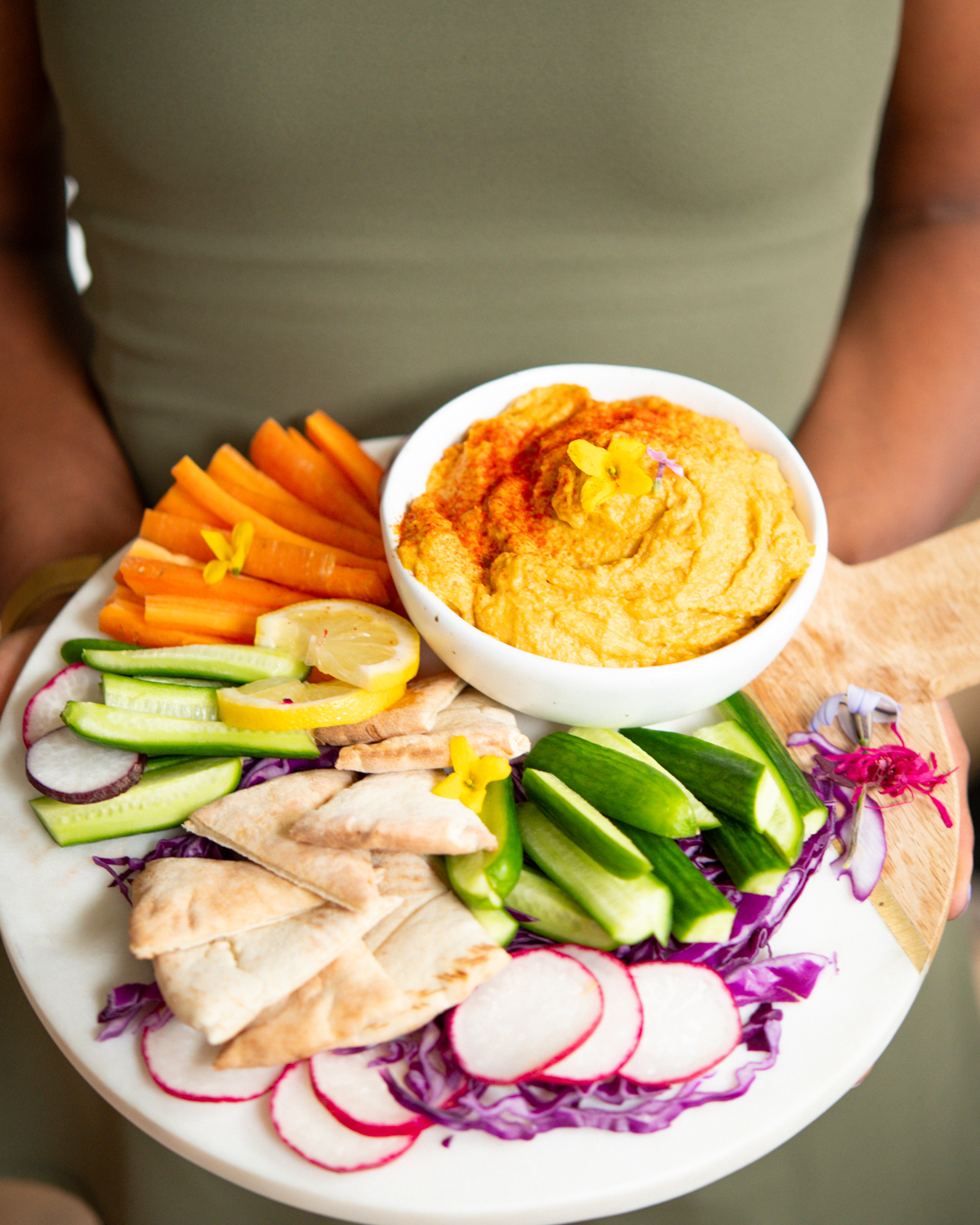 holding hummus platter