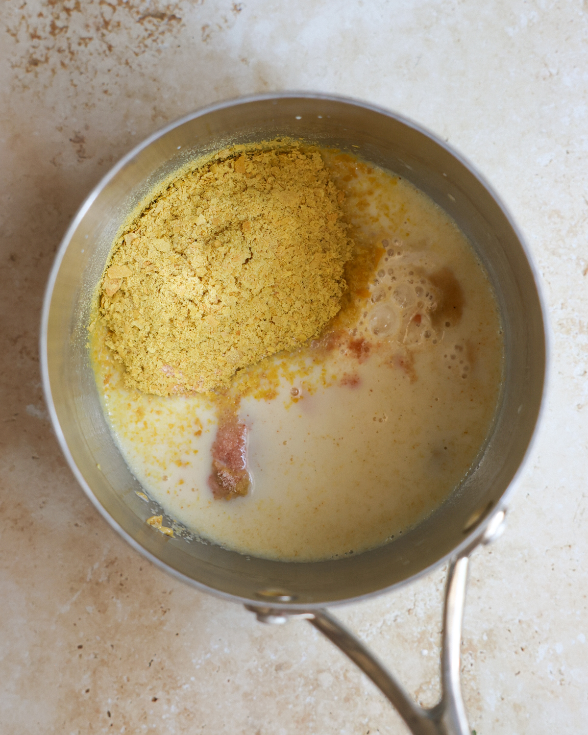 overhead cheese sauce ingredients in pot