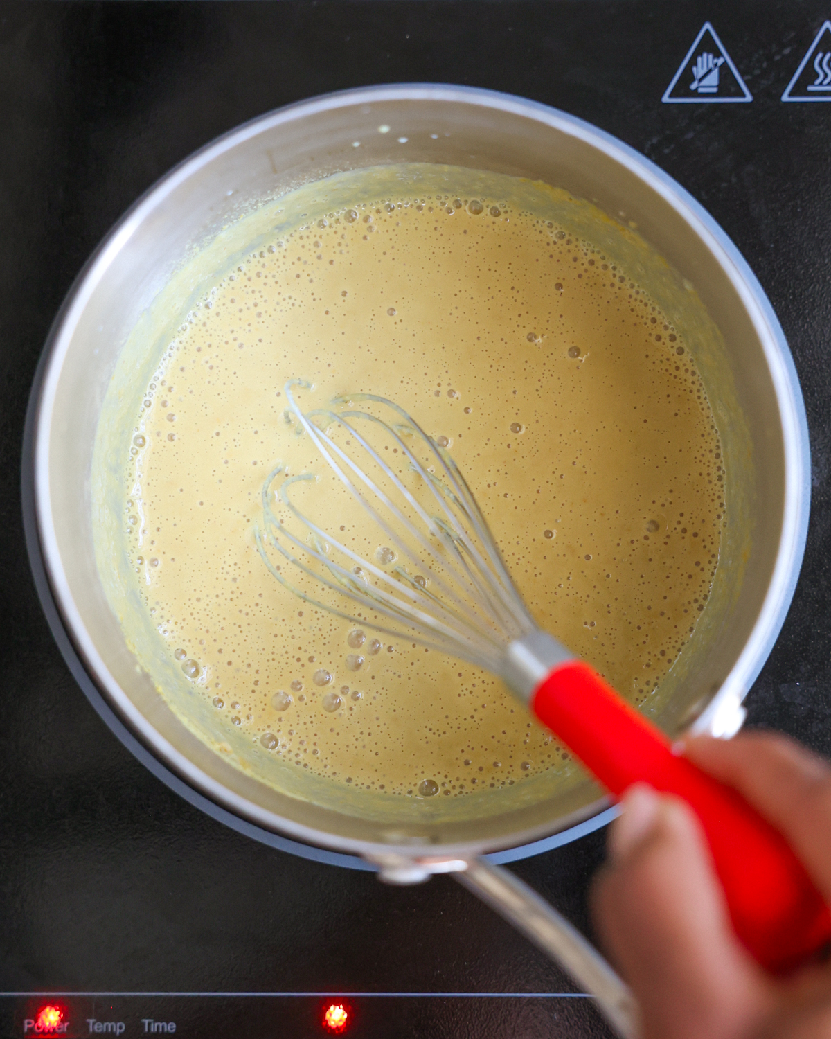 whisking cheese sauce