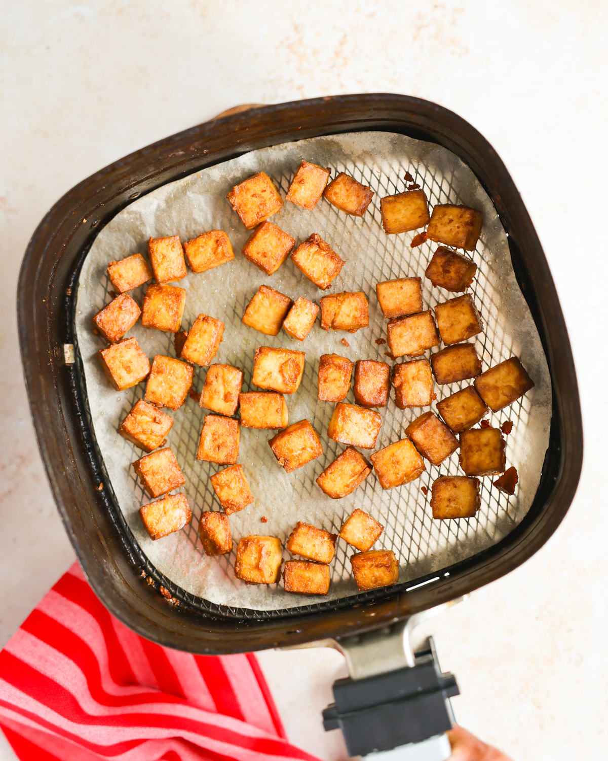overhead air fried tofu in air fryer basket