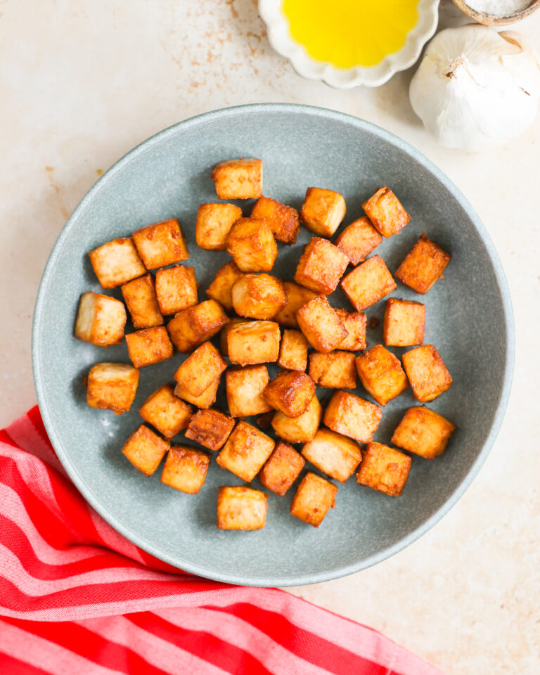 Air fried cubed tofu on plate.