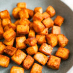 Air fried tofu on a plate.