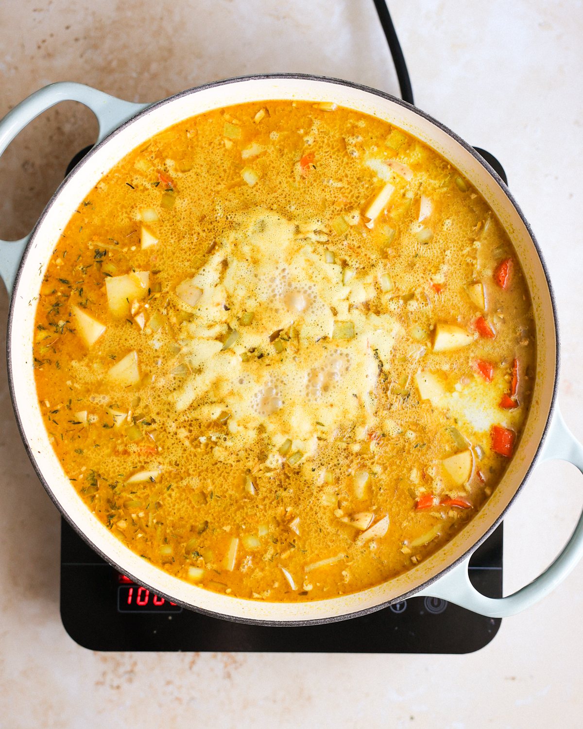Bringing the large pot of Jamaican style chickpea curry to a simmer.