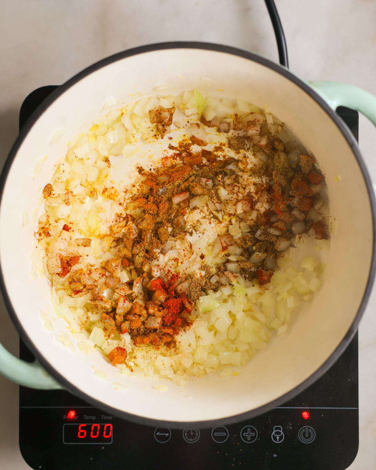 overhead spices added to veggies in pot