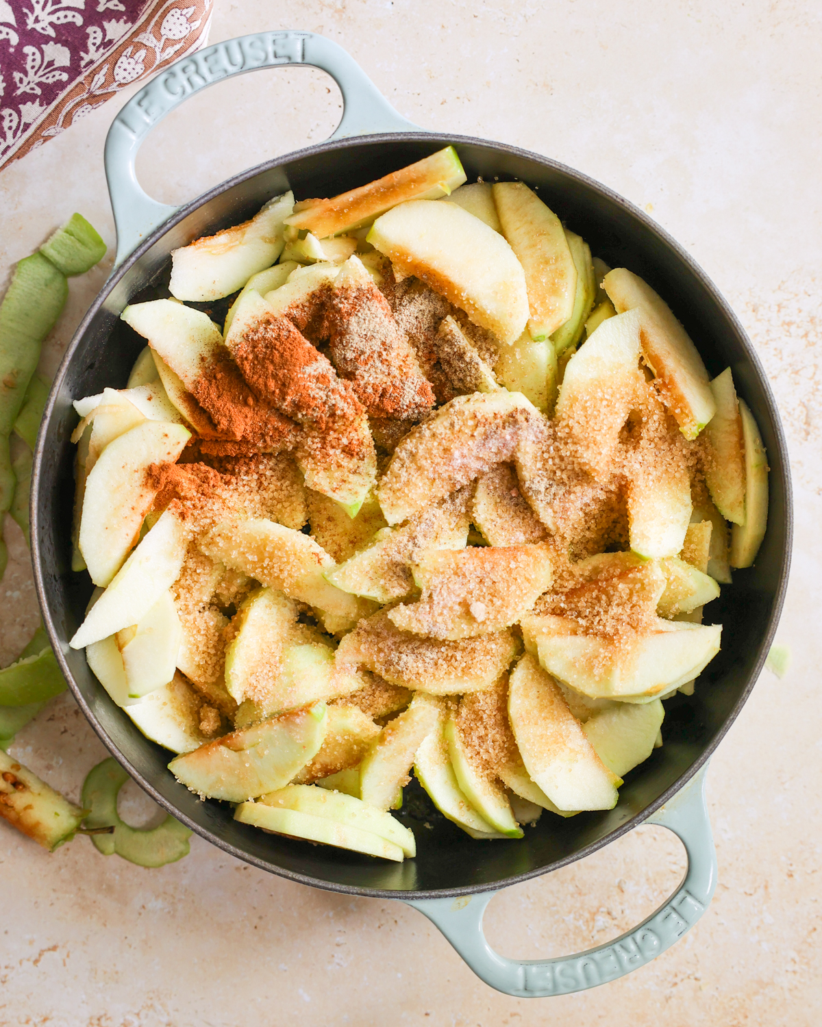 overhead spices and sugar on apple slices