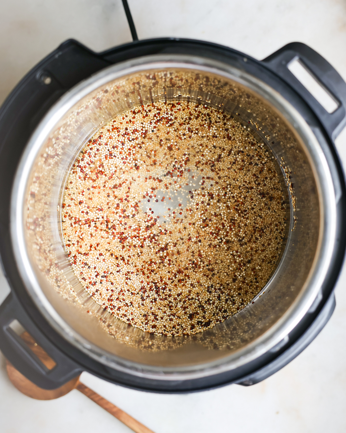 overhead water and quinoa in pot