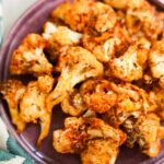 close up of air fryer cauliflower on a purple plate