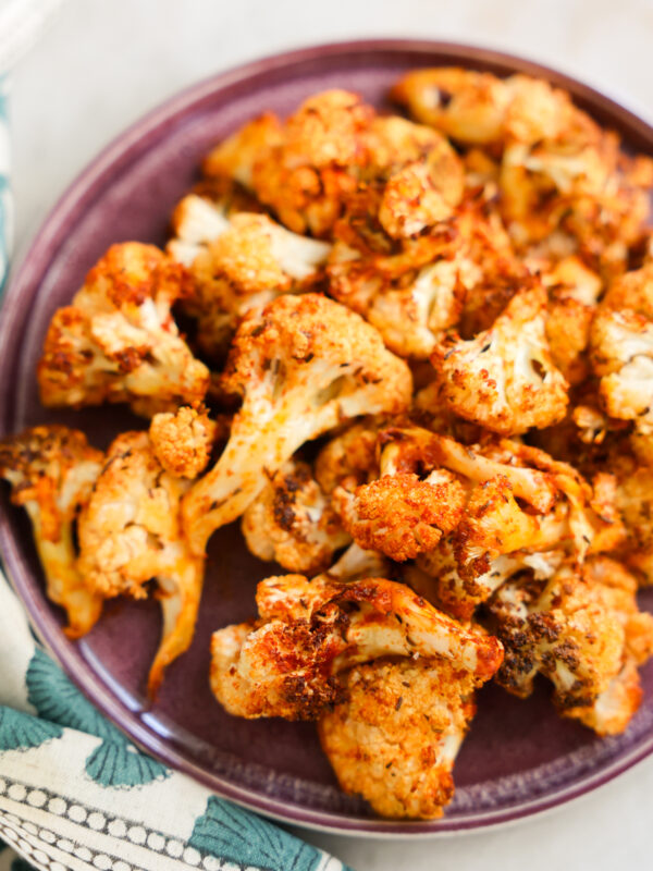 close up of air fryer cauliflower on a purple plate