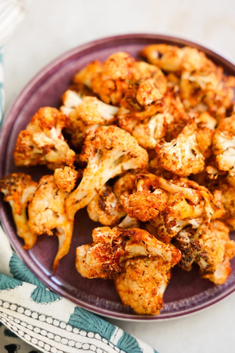 close up of air fryer cauliflower on a purple plate