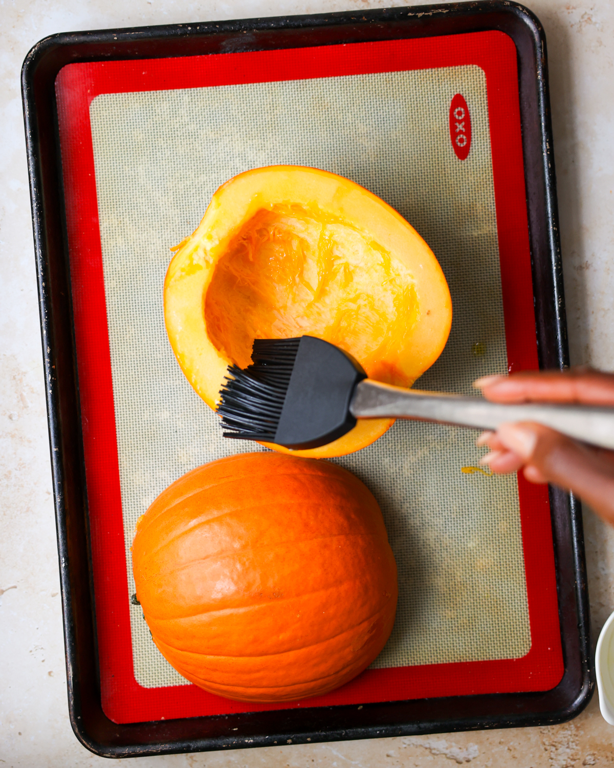 brushing pumpkin with oil