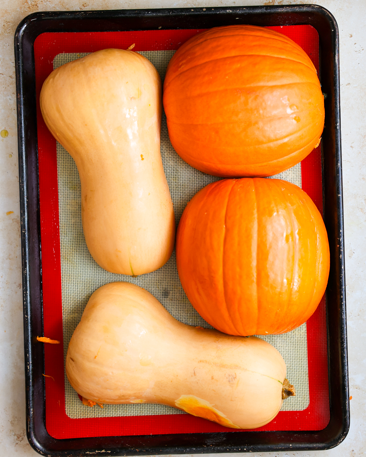overhead raw pumpkins on baking sheet