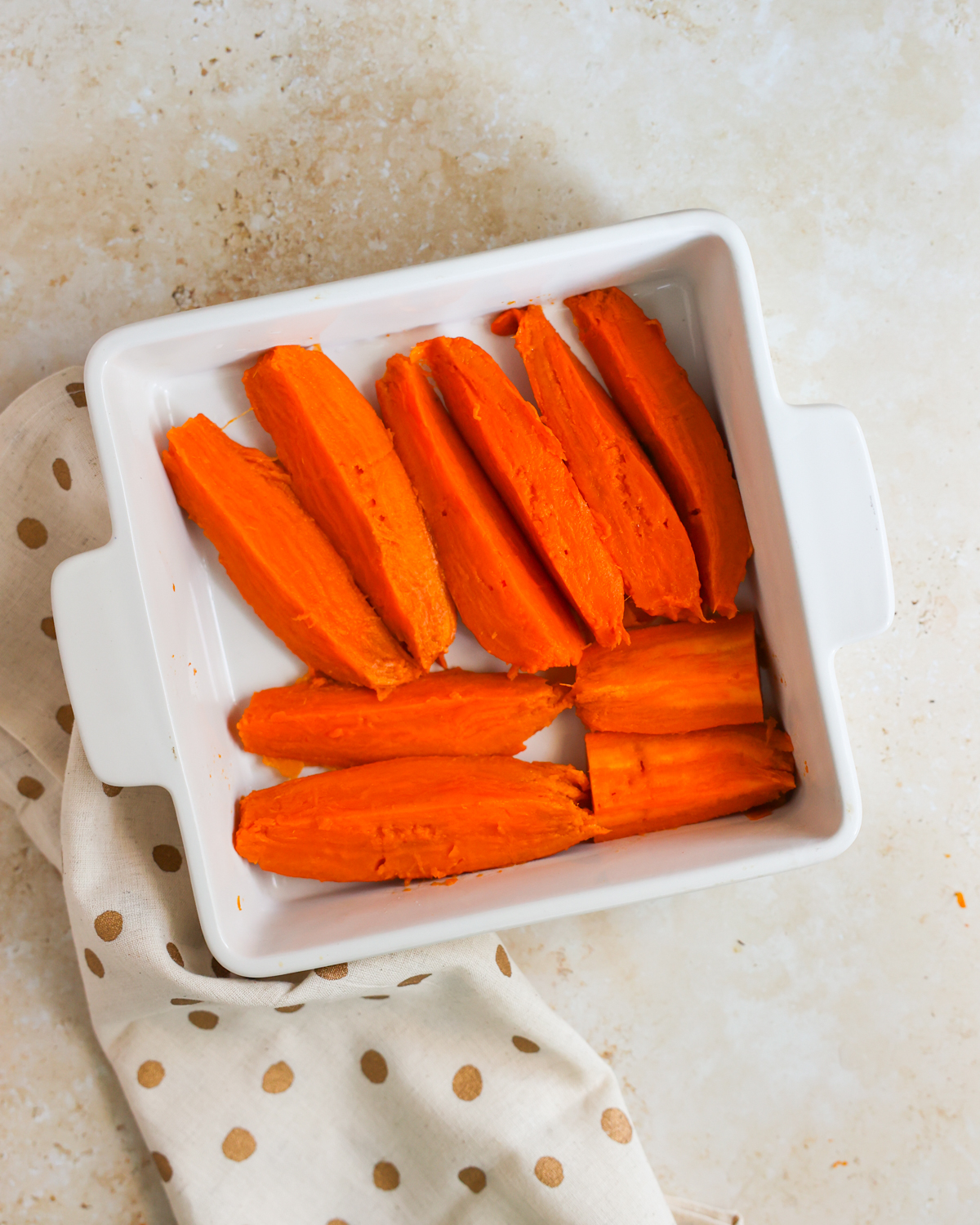 sliced sweet potatoes in baking dish