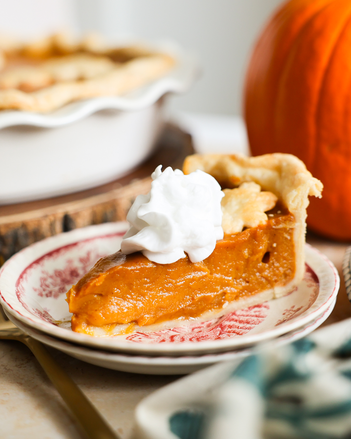 slice of pumpkin pie with whipped cream