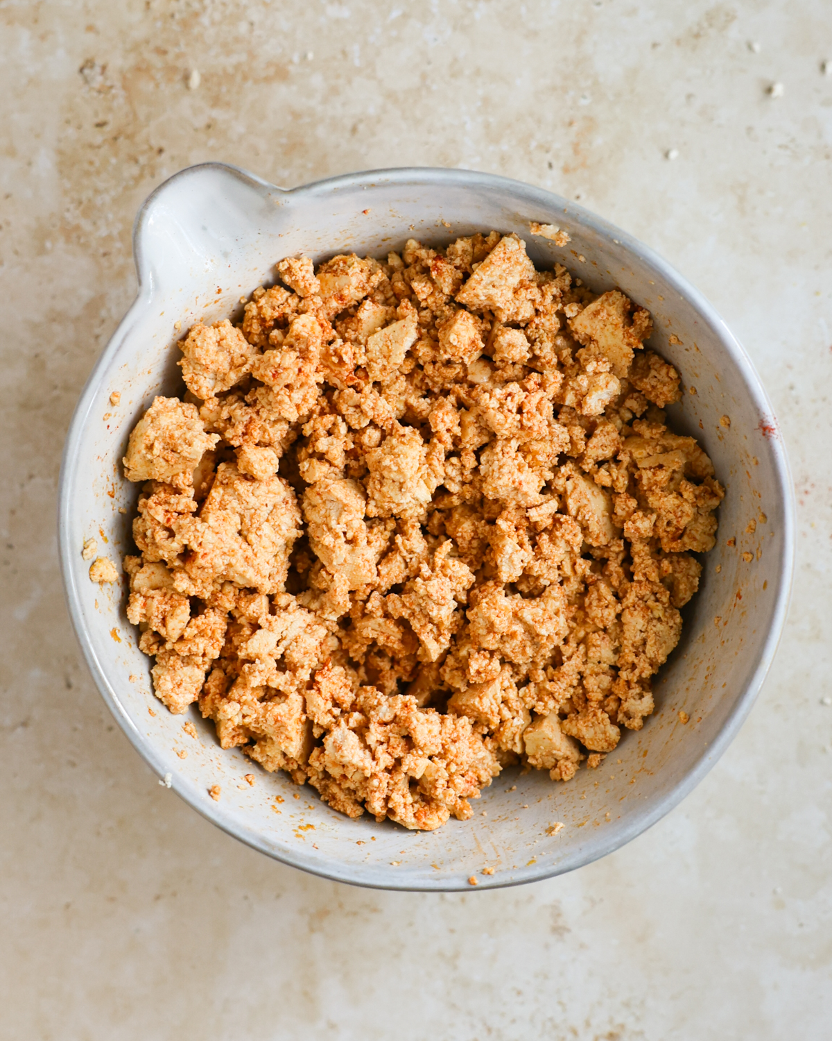 overhead of stirred spiced tofu in bowl