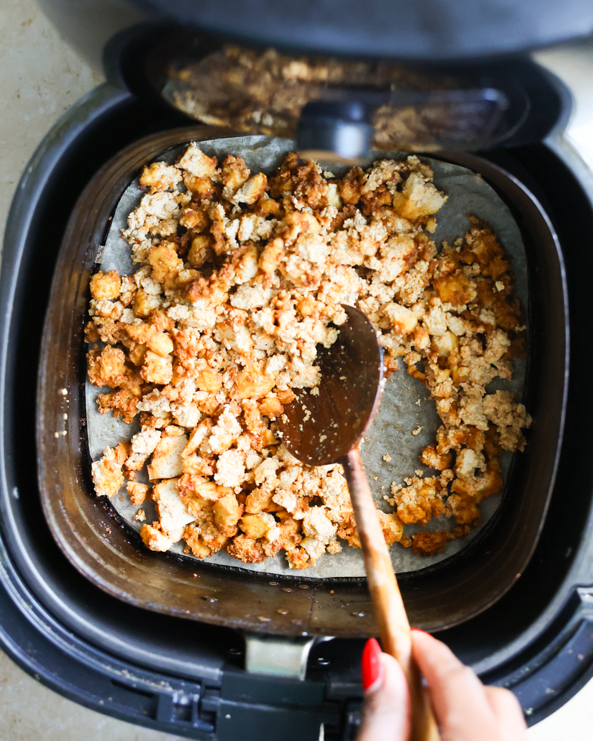 stirring tofu in air fryer