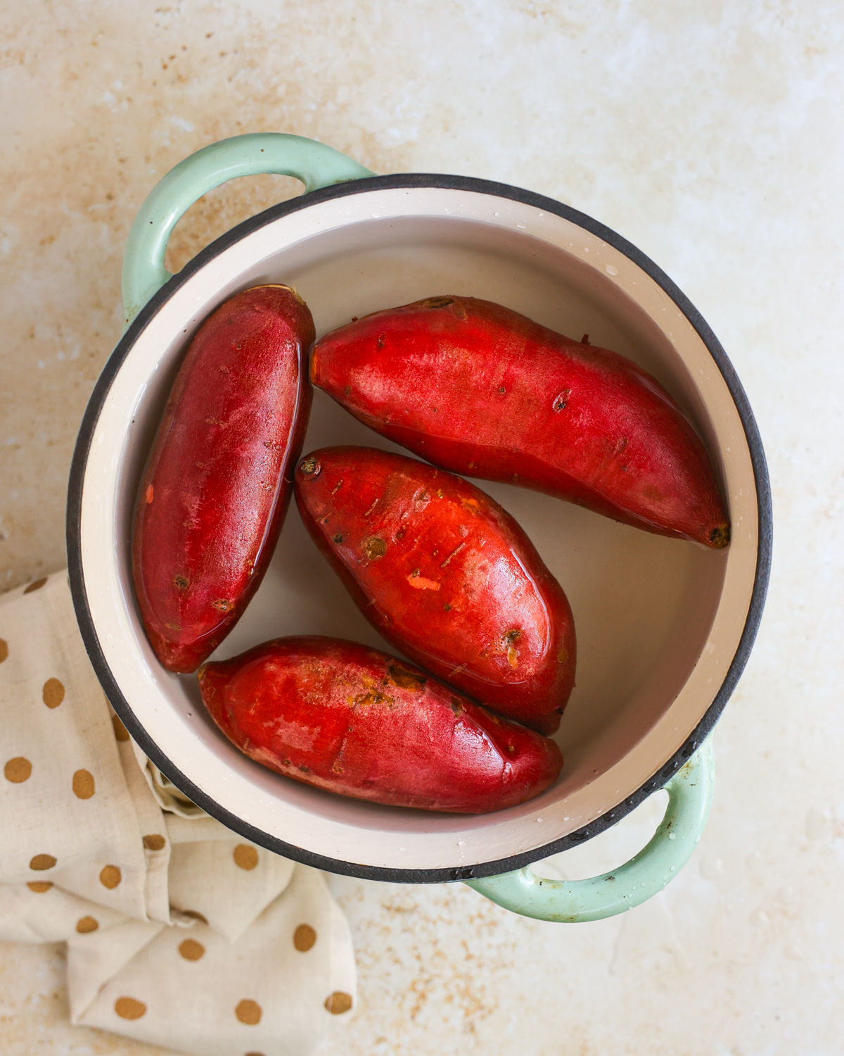 overhead of sweet potatoes in pot of water
