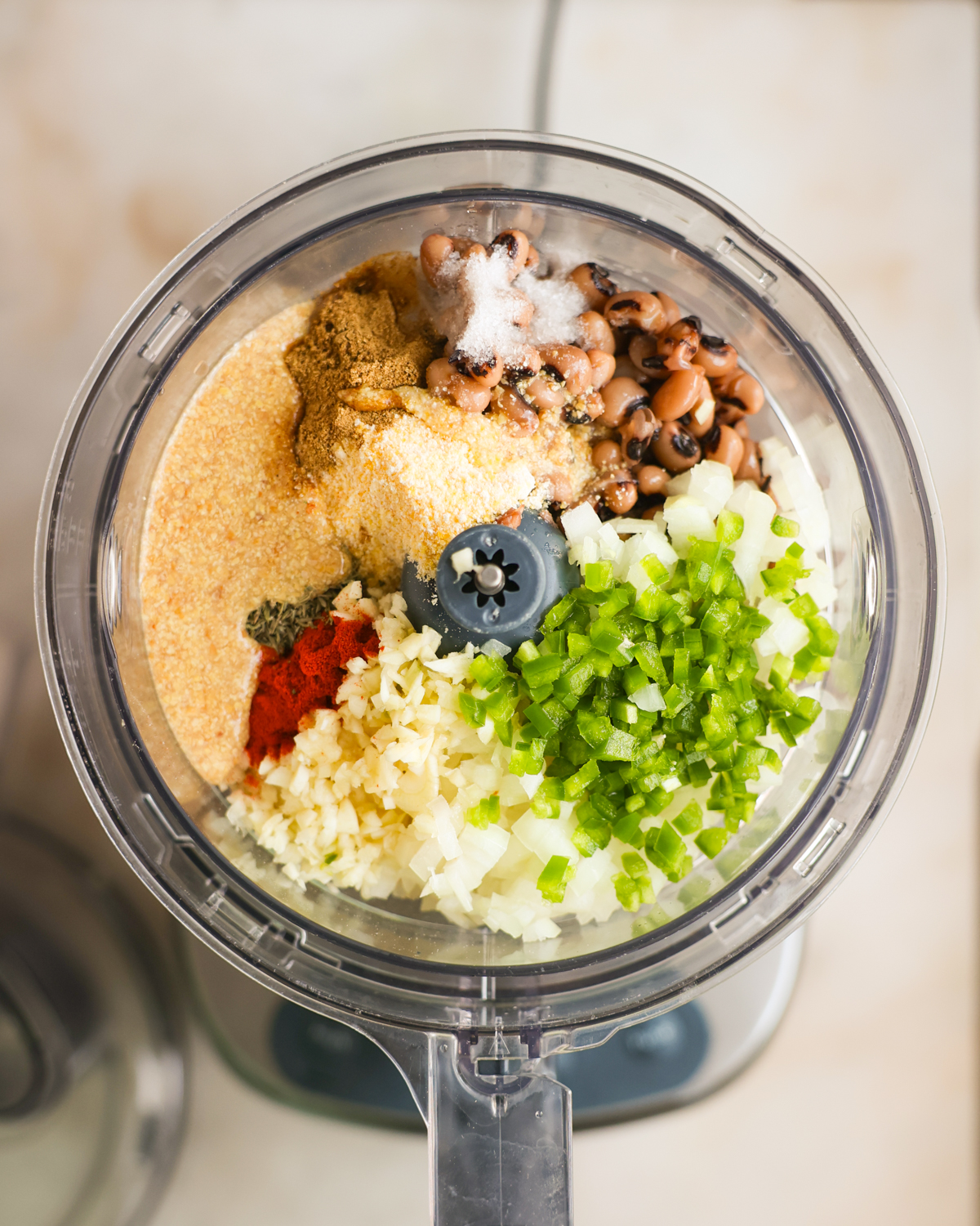 overhead of fritter ingredients in food processor