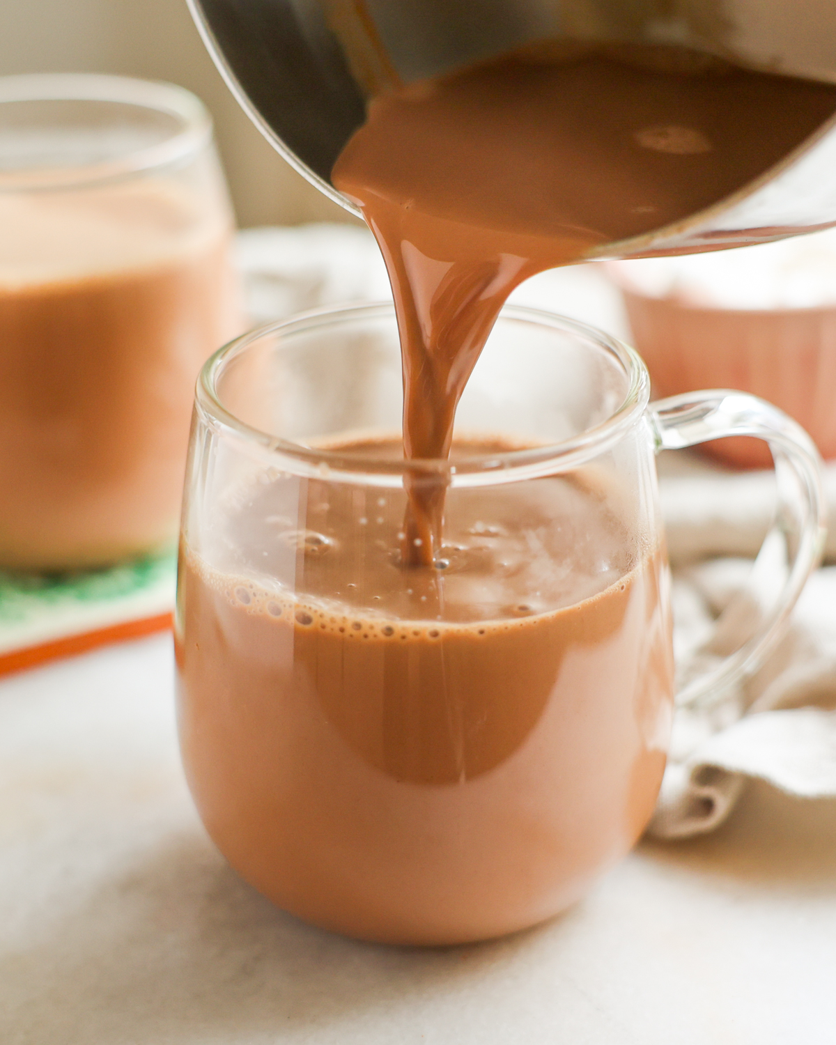pouring hot chocolate into mug