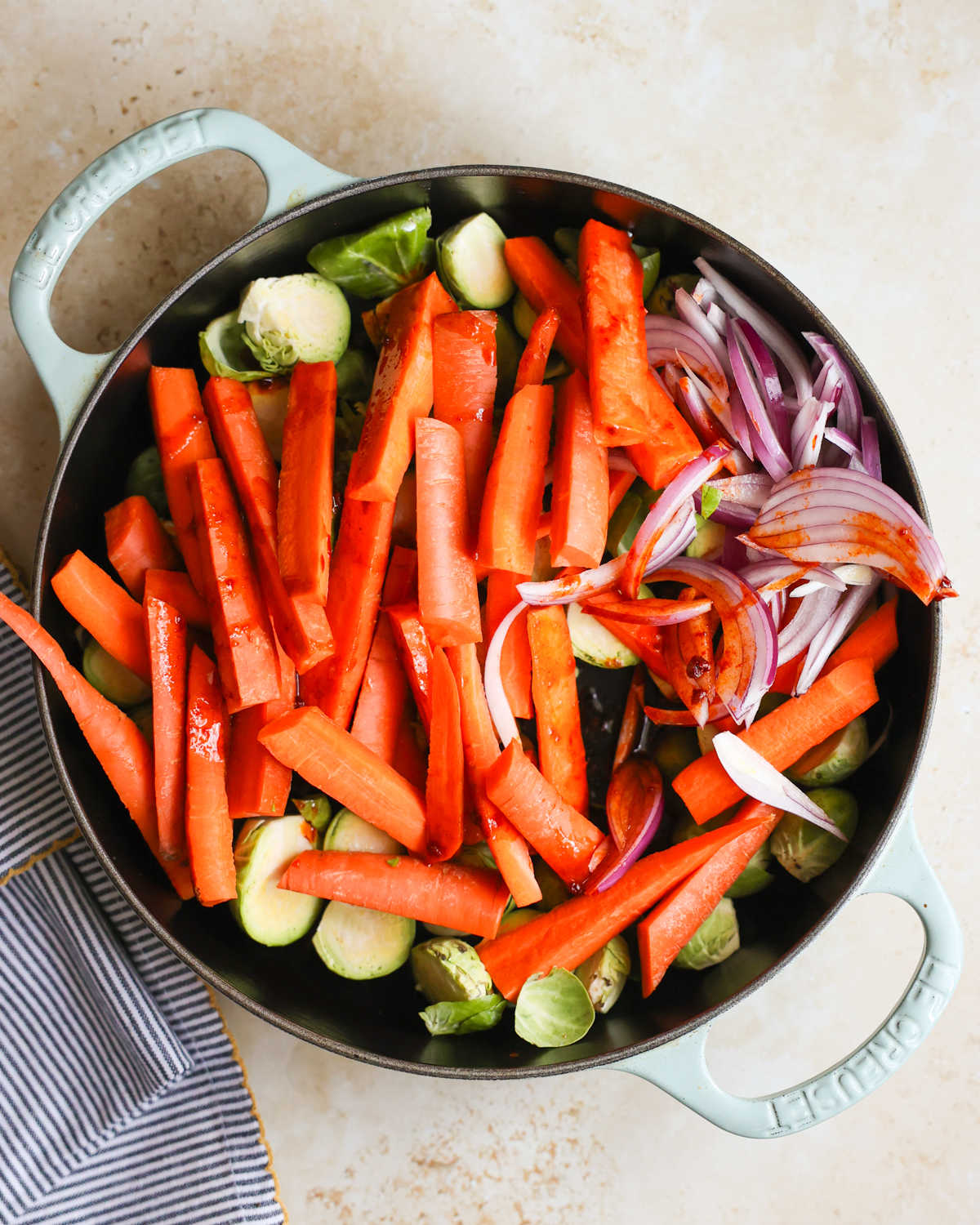 overhead chopped veggies in skillet with spices