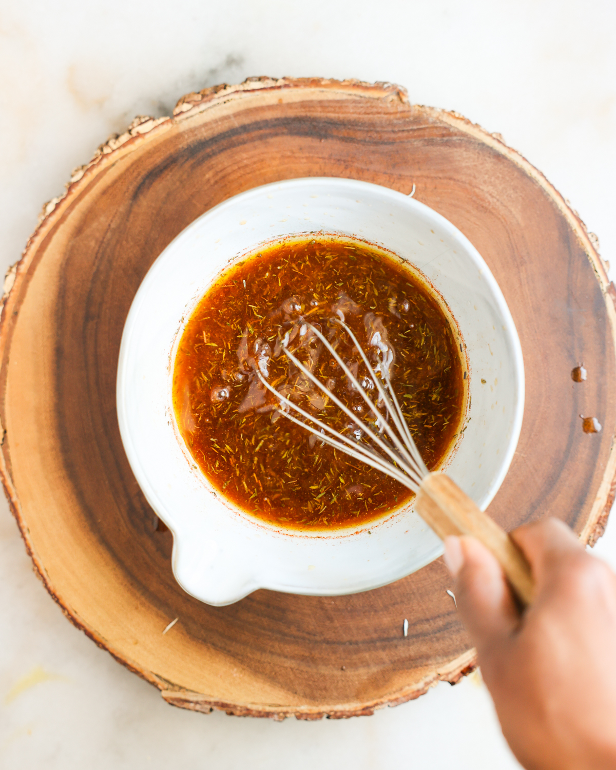Whisking mushroom marinade in a bowl. 