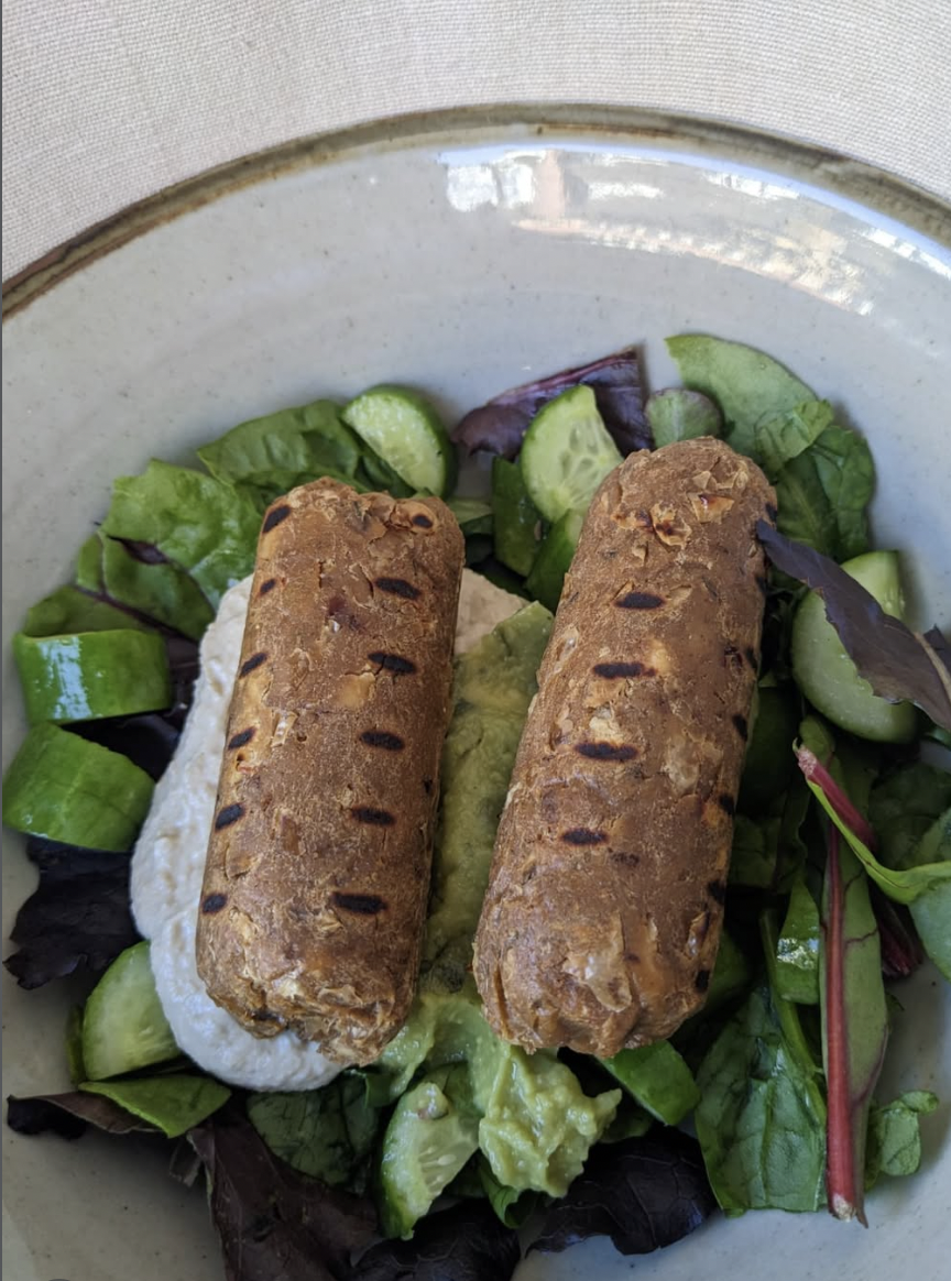 Vegan sausages on bed of lettuce.