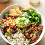 Vegan burrito bowl on table.