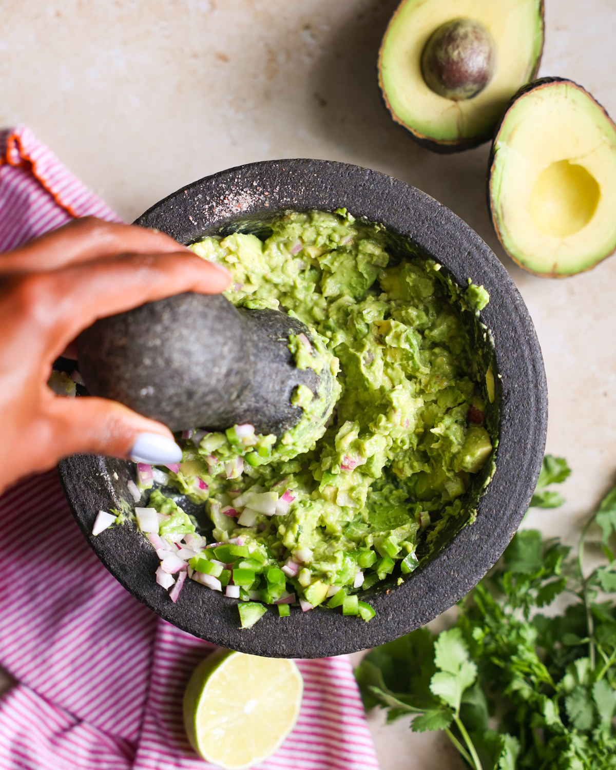 Mashing guacamole in a bowl.