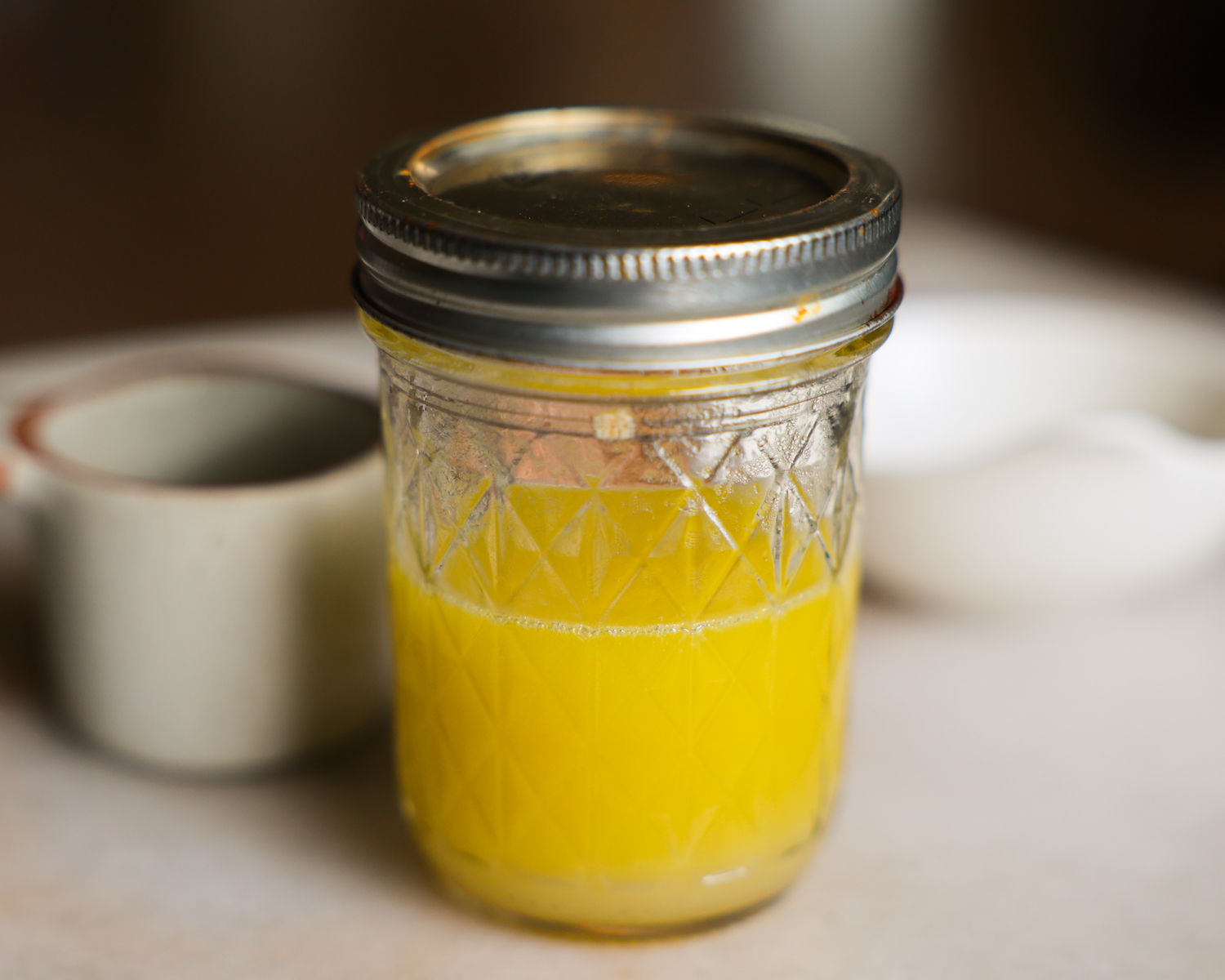 Lime vinaigrette for watermelon salad in a glass jar.