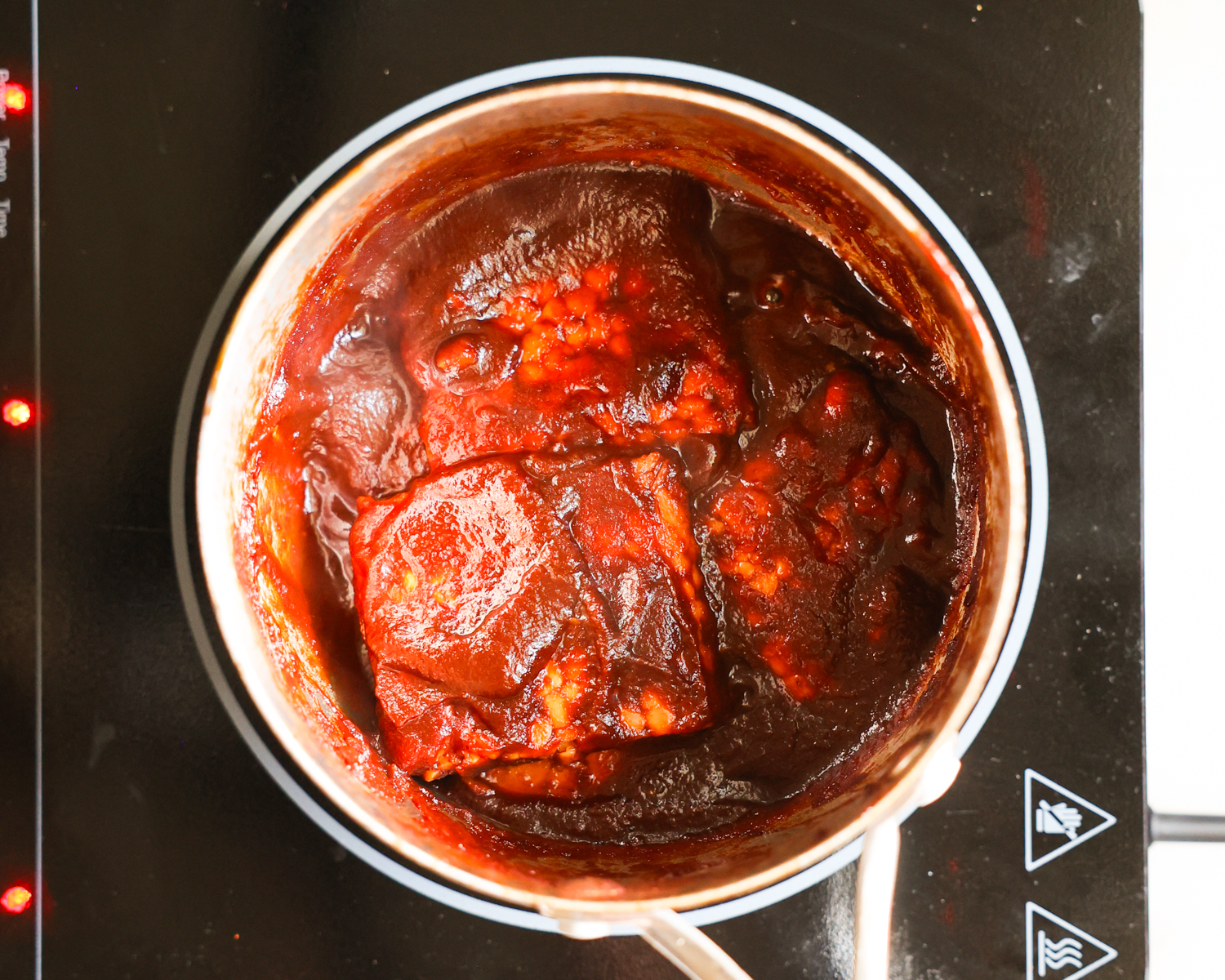 Simmering BBQ tempeh in pan.