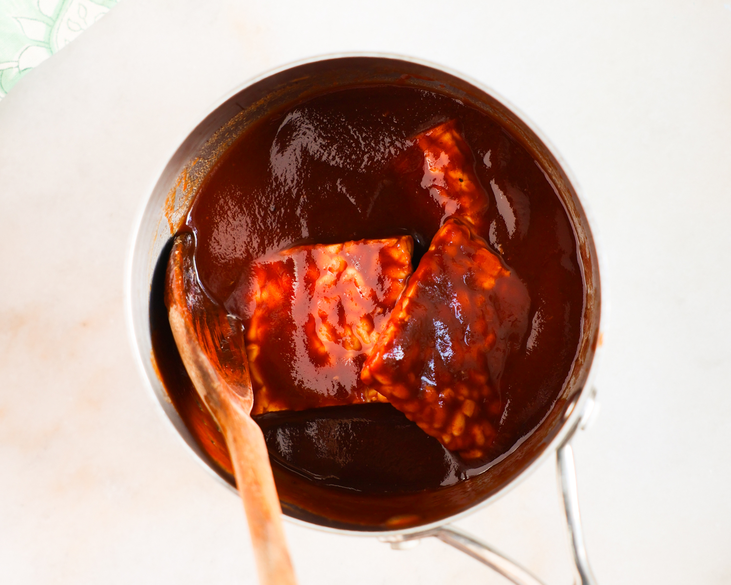 Stirring tempeh in BBQ sauce.