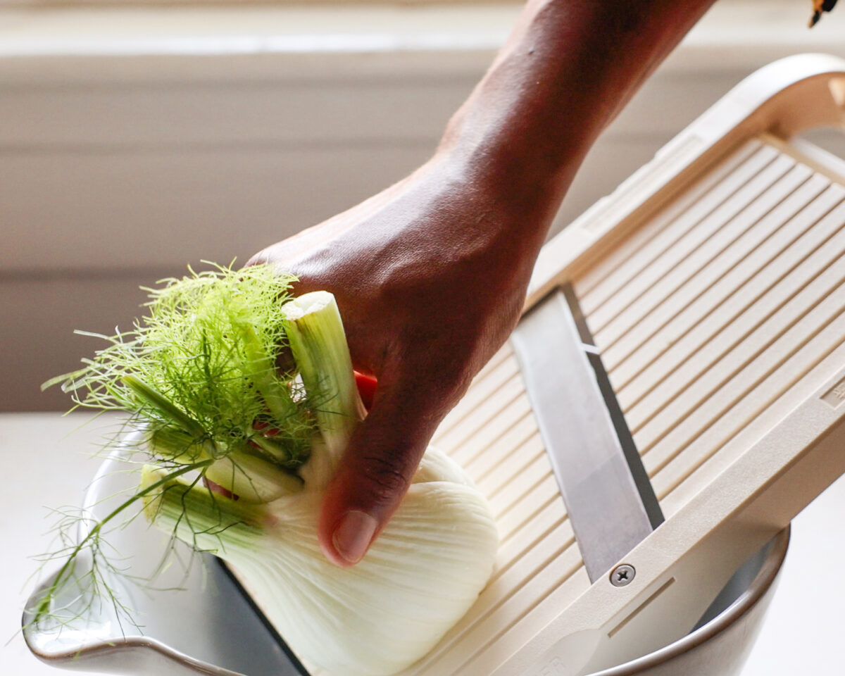 Shredding fennel on a mandoline.