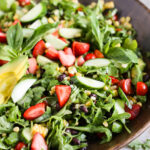 Easy summer salad with strawberries, tomatoes, corn, and arugula.