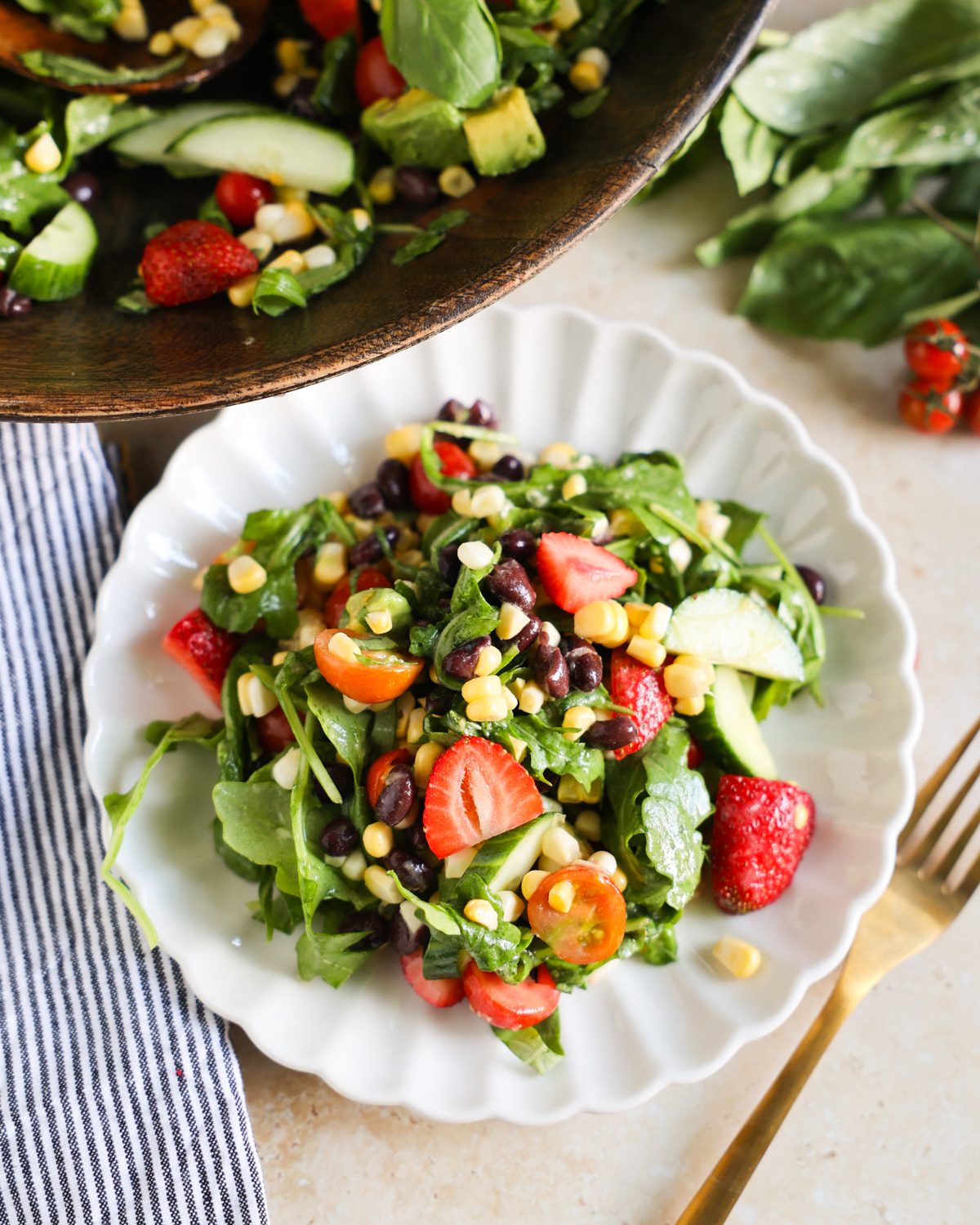 Summer salad served on a white plate.
