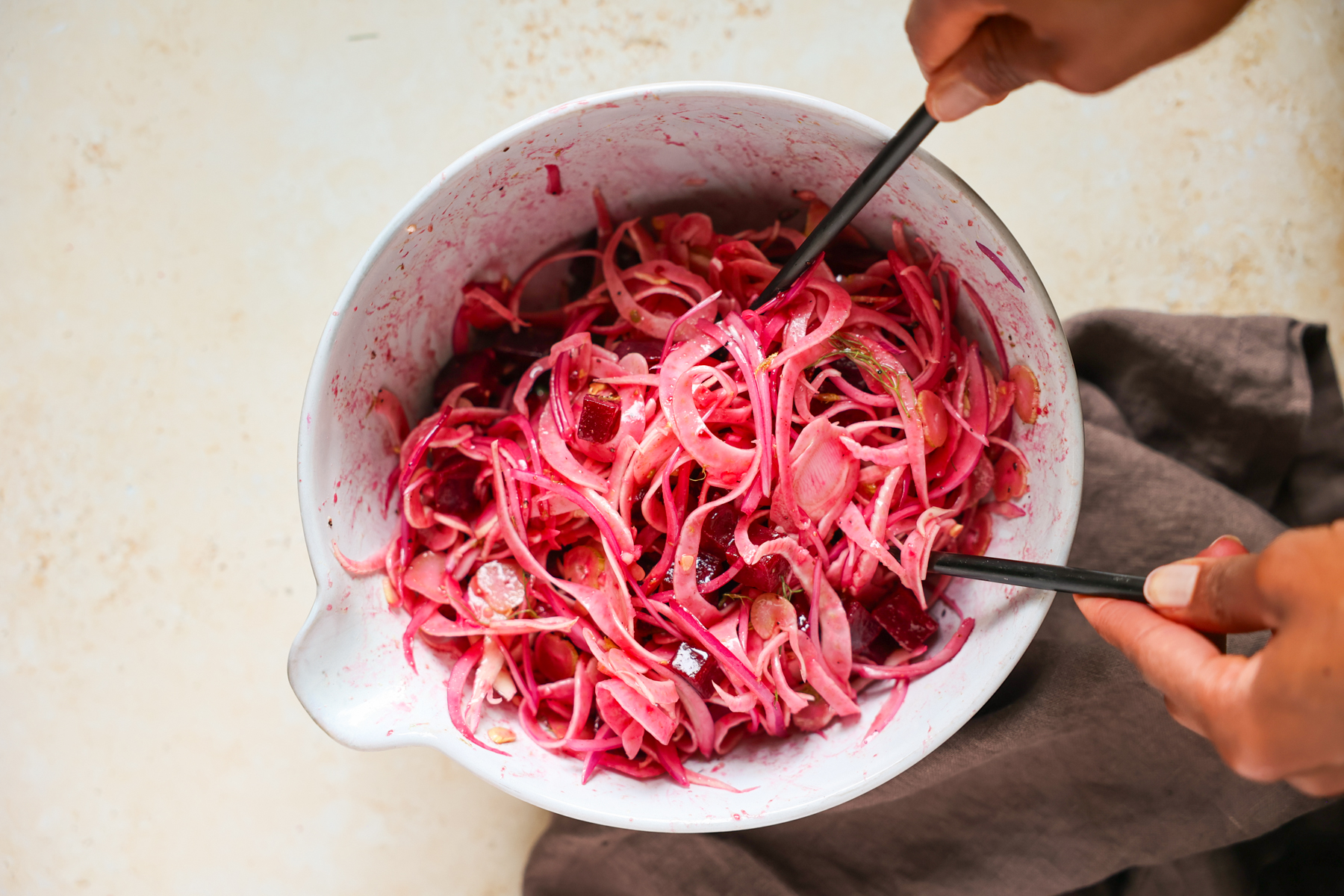 Tossing beet fennel salad.