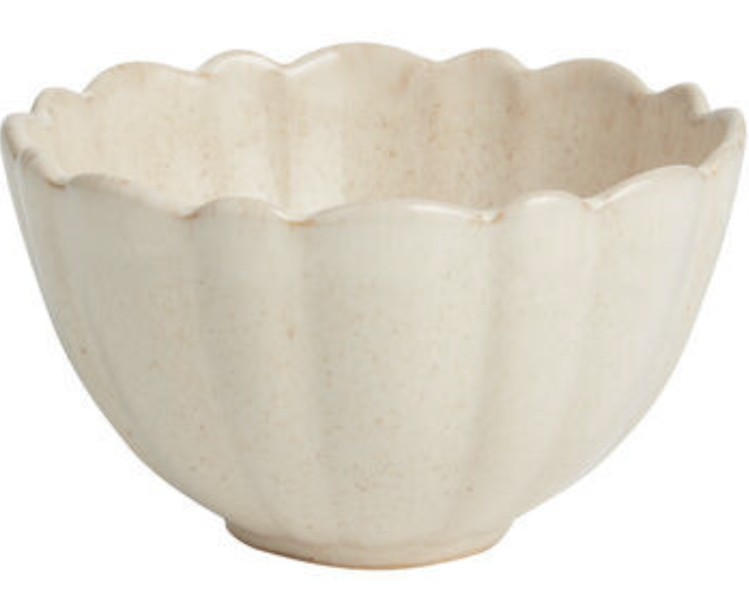 Ceramic cereal bowl with fluted edges.