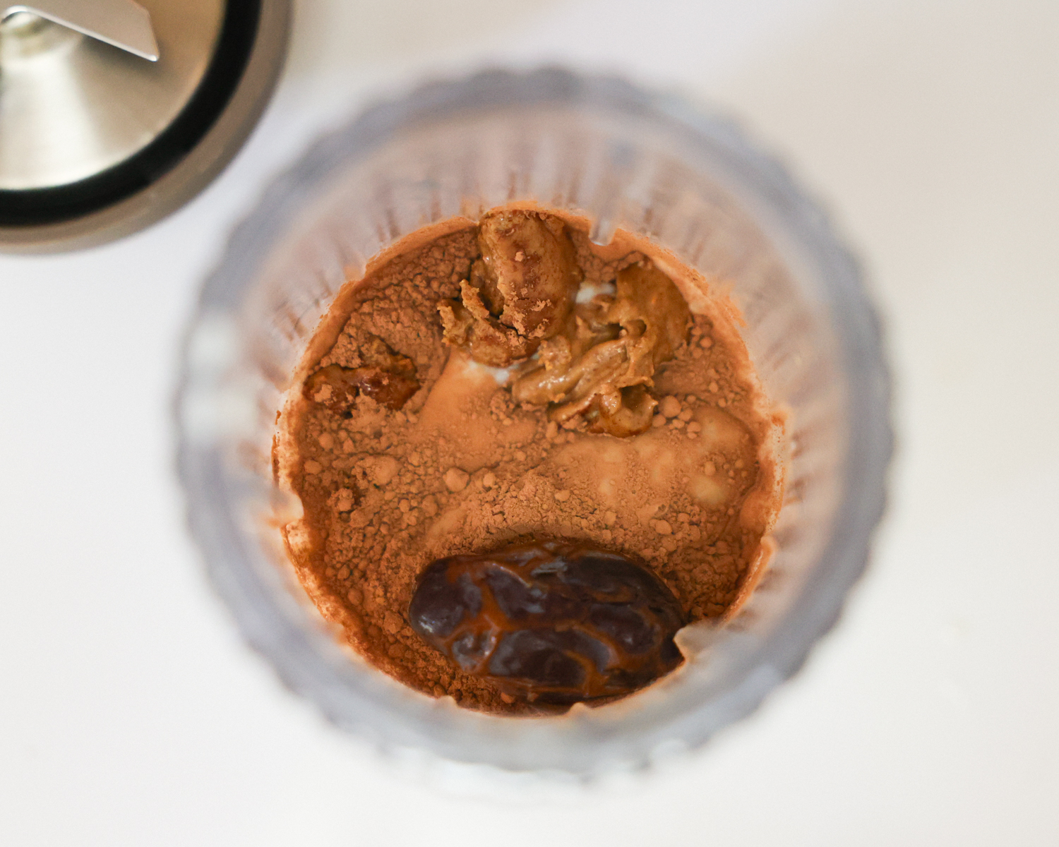 Chocolate smoothie ingredients in a blender.