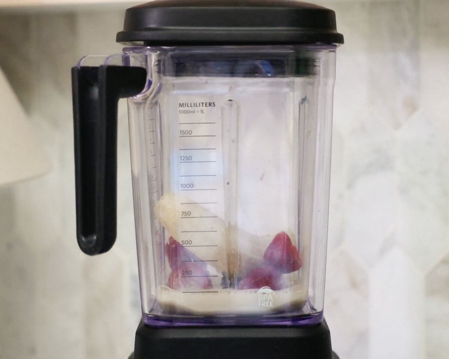 Bananas, strawberries and soy milk in a blender.