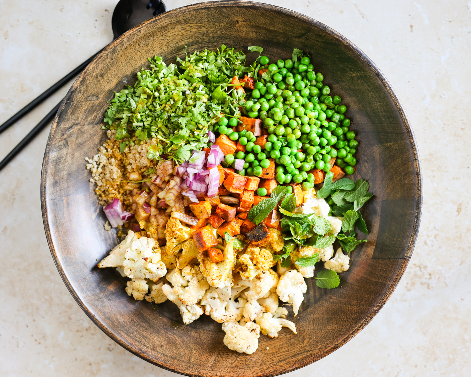 Cauliflower salad components topped with the curry dressing.