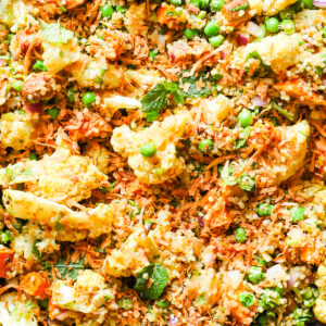 Cauliflower salad with sweet potatoes, peas, and curry dressing.
