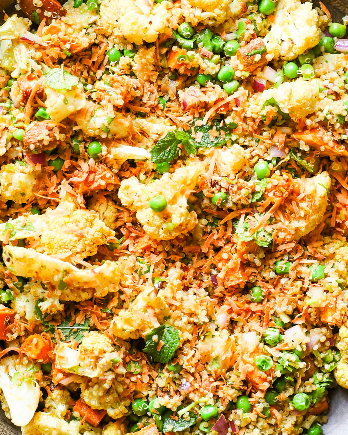 Cauliflower salad with sweet potatoes, peas, and curry dressing.
