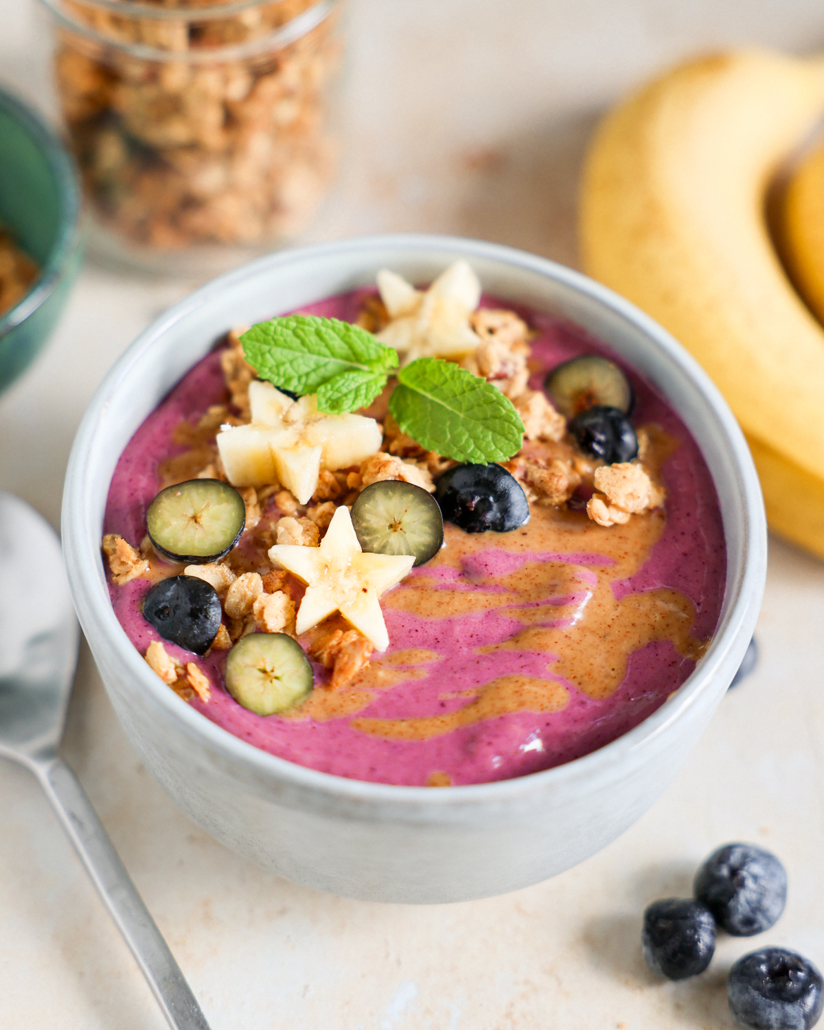 Smoothie bowl topped with fruit and granola.