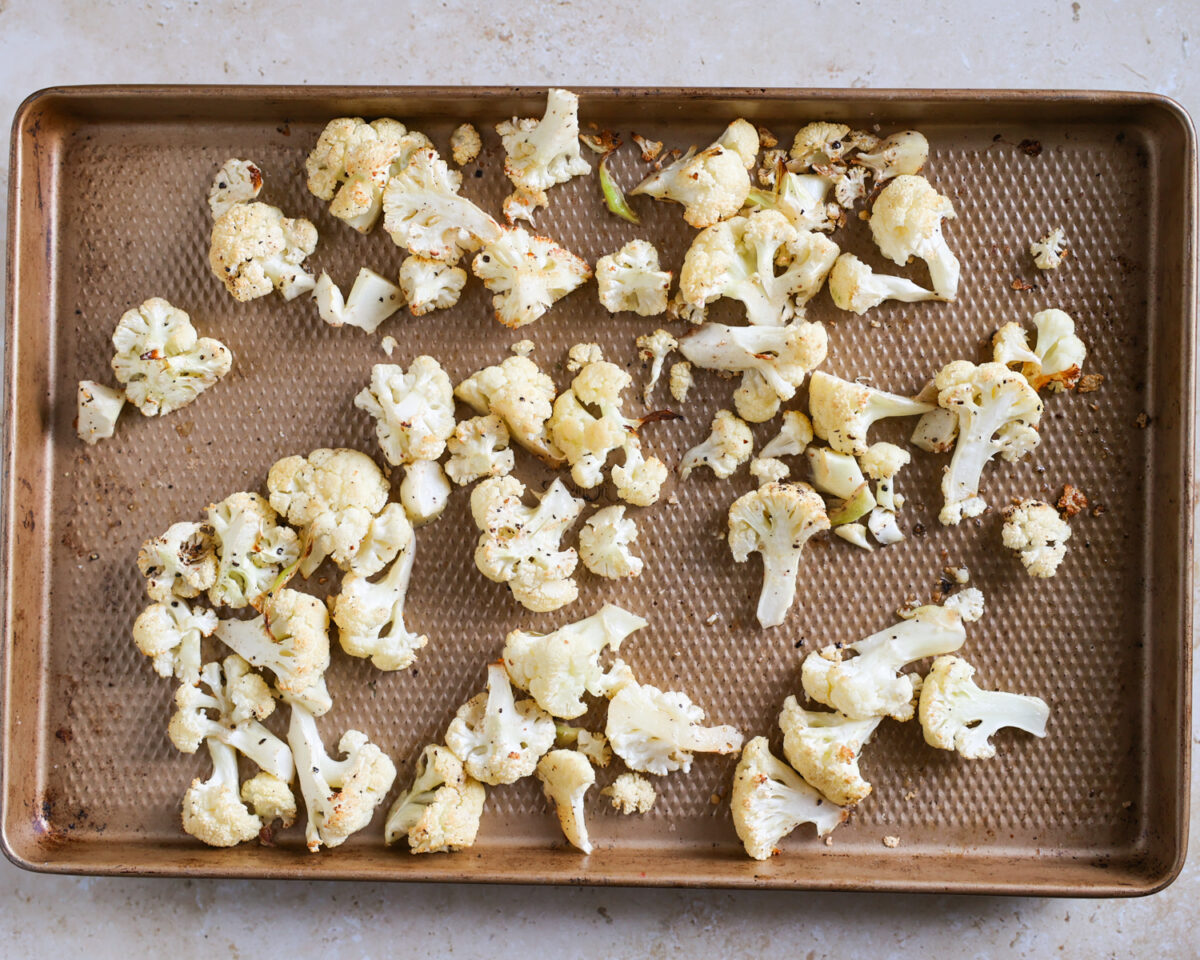 Roasted cauliflower on a baking sheet.