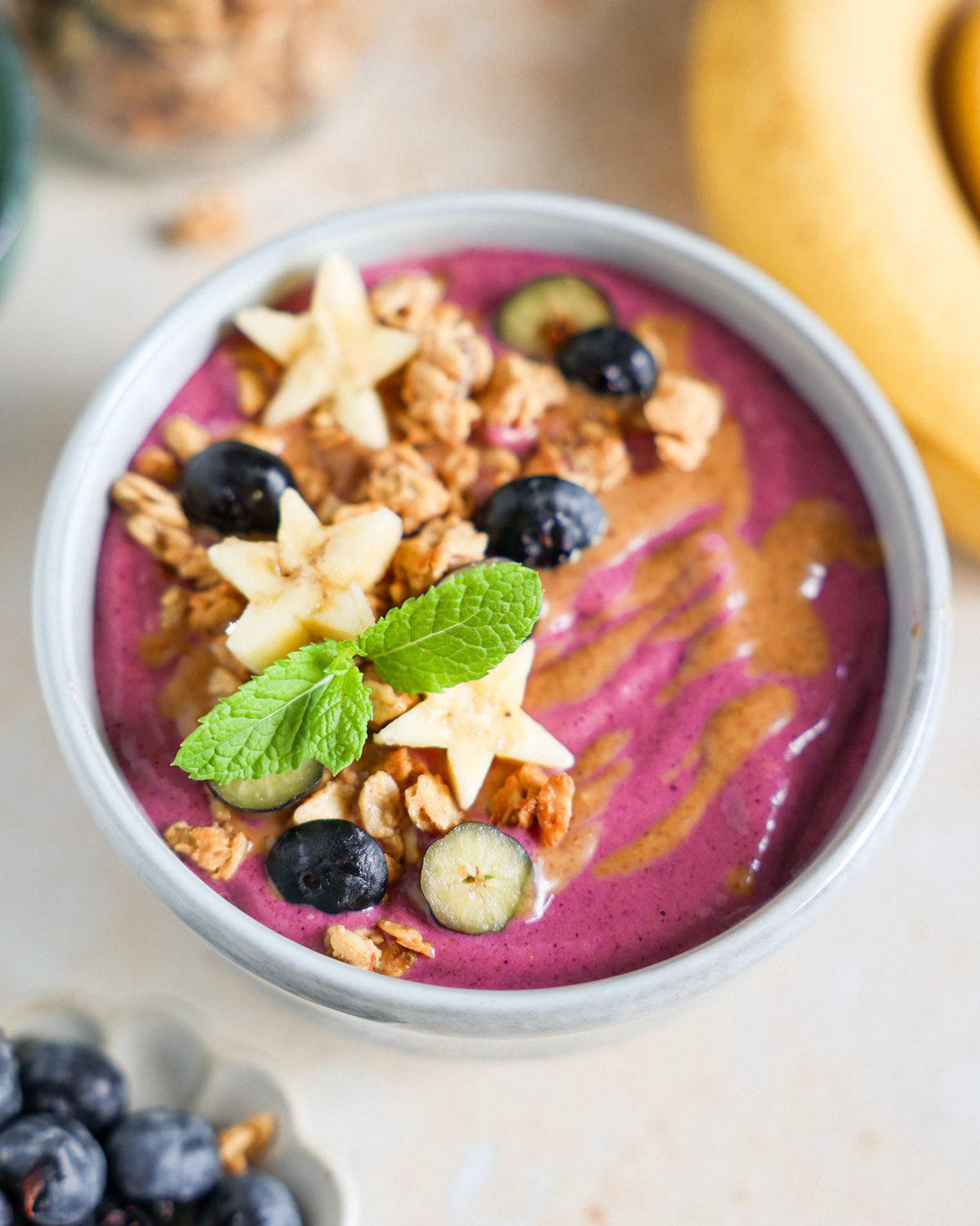 Smoothie bowl with fresh fruit and granola topping.
