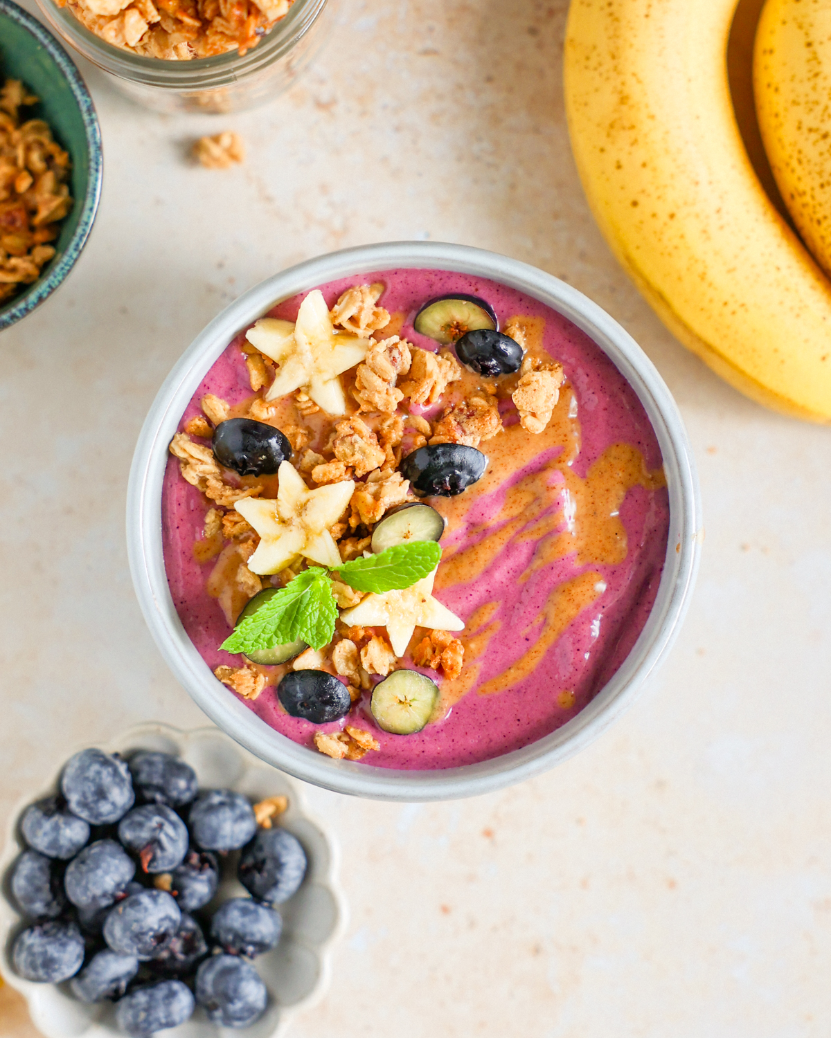Smoothie bowl with fresh fruit toppings and granola.